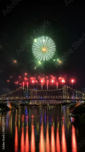 Spectacular Fireworks Display Over City River at Night