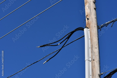 Three phase AC electrical lines disconnected on power pole. 