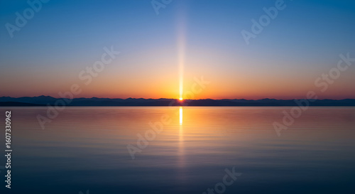 Serene Sunrise over Calm Lake Mountain View