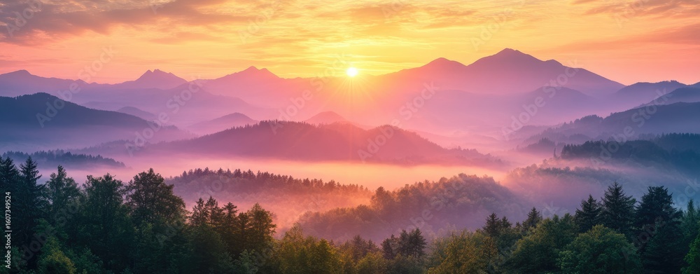 Obraz premium Sunrise over misty mountain ranges (2)