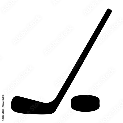 A hockey stick and puck, ready for action on the ice rink