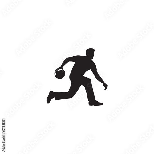 Silhouette of a male bowler throwing a bowling ball down the lane