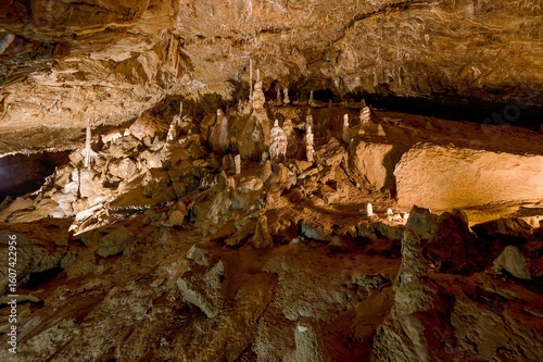 Karst formations inside Punkva Cave with illuminated stalactites and stalagmites, Moravian Karst, Czech Republic.