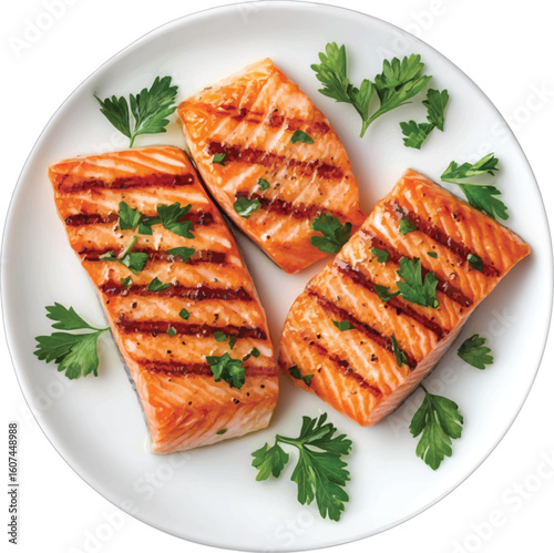 Grilled salmon fillets with parsley garnish on white plate fish seafood