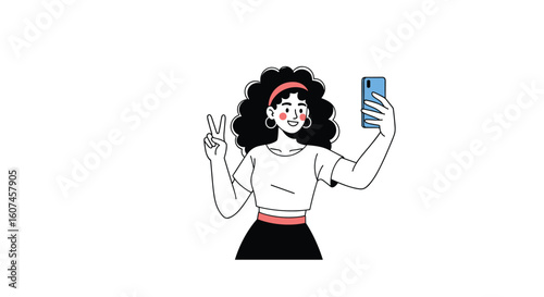 A stylish young woman with curly hair poses for a selfie while holding her phone and waving happily at the camera