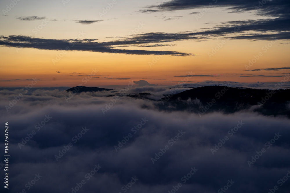 Fototapeta premium blue hour over the clouds or fog of tuscany in a view from Montepulciano into the going light of the day