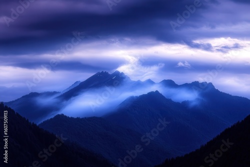 Layers of misty mountains create a serene and ethereal landscape