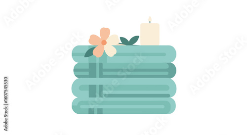 Spa towels stacked with a candle and a flower for relaxation and wellness.