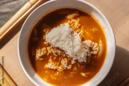 overhead shot of a curry soup with rice