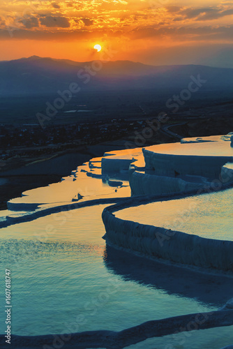 Sunset over Pamukkale travertine terraces with golden reflections, Denizli, Turkey