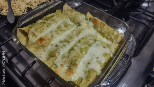 Delicious green chicken enchiladas Suizas with melted cheese, healthy homemade food.