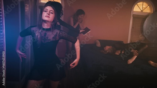 Gothic woman dances while exorcism performed in background