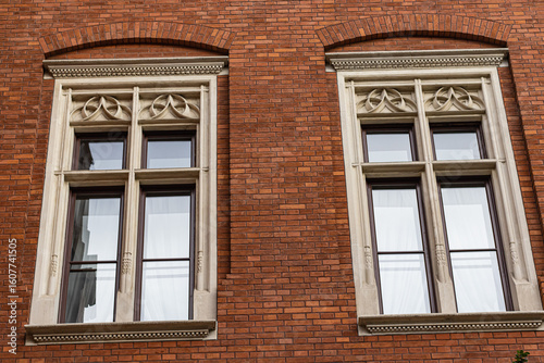 Ornate Stone Framed Windows on a Red Brick Building