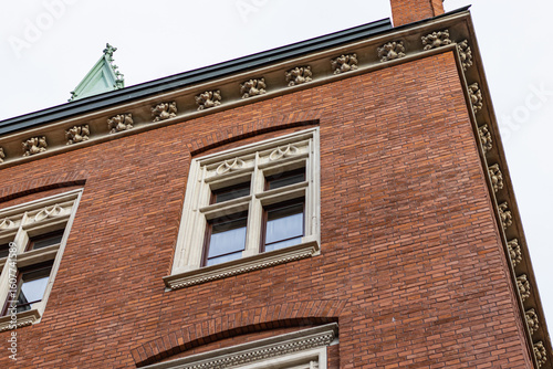 Ornate Stone Details on a Red Brick Building Corner