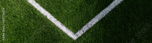 Bright green artificial turf football field with white lines, top view