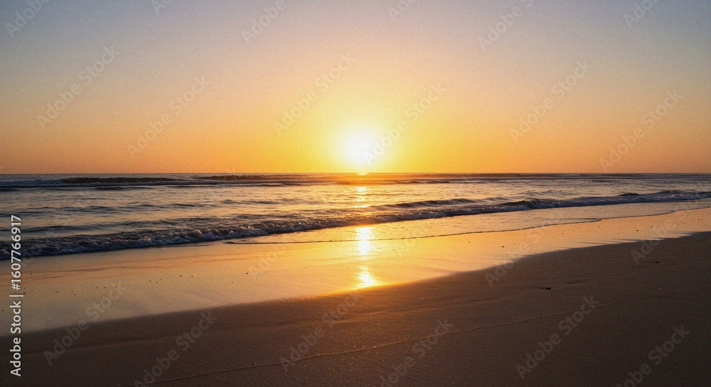 Fototapeta premium Golden Sunrise Over Ocean Waves on a Sandy Beach