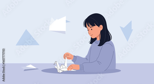 Girl Making Origami Paper Craft Sitting at Desk Indoors Creative Hobbies