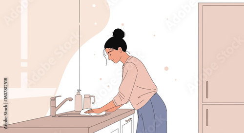 Woman Doing Housework In Kitchen Cleaning Surface After Cooking Meals