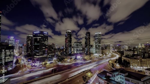 Wallpaper Mural Cityscape glows at night. Light trails from vehicles create motion across the avenues. A vibrant, urban view Torontodigital.ca