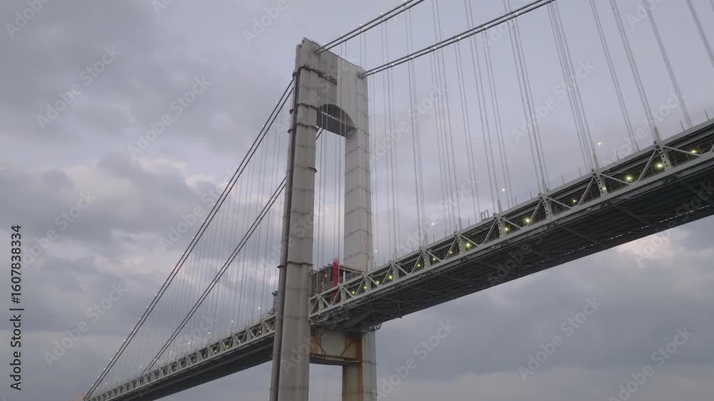 Drone shot looking up at the Verrazzano-Narrows Bridge on an overcast day Drone shot looking up at the Verrazzano-Narrows Bridge on an overcast day
