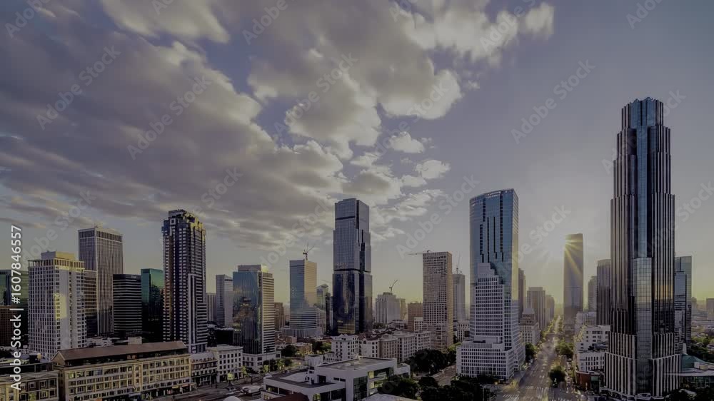 Dramatic city skyline at dusk. Skyscrapers pierce the sky under a textured, golden-tinged cloudscape Dramatic city skyline at dusk. Skyscrapers pierce the sky under a textured, golden-tinged cloudscape