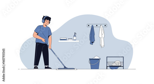 Young Man Enjoying Housework While Listening To Music With Headphones At Home
