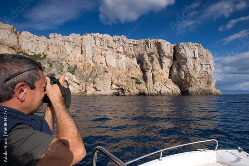 Punta Giglio promontory from the sea. Alghero, SS, Sardinia, Italy