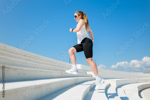 Runner training on the steps of a modern outdoor structure
