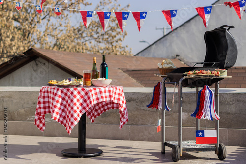 Chilean Independence Day: Rooftop barbecue with traditional food, empanadas, completos and patriotic decoration for Independence Day