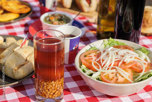 Chilean Independence Day: Traditional Chilean salad, empanadas and mote con huesillo on festive table
