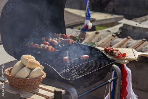 Chilean Independence Day: traditional grill with longanizas and meat skewers smoking