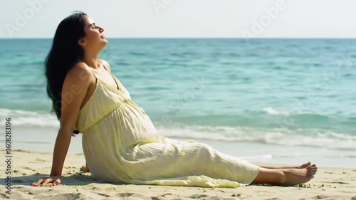 Pregnant woman relaxes on tropical beach