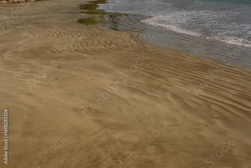 Fototapeta Naklejka Na Ścianę i Meble -  Tranquil Ocean Shoreline, Beautiful Seascape with Incoming Tide, Pristine Beach and Blue Water, Coastal Landscape with Soft Waves, Peaceful Beach Scene, Vacation Paradise: Sandy Shore,