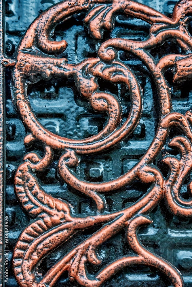 Part of ornate metal door featuring intricate carvings with detailed patterns and textures, showcasing craftsmanship and artistic design elements in a captivating visual composition Part of ornate metal door featuring intricate carvings with detailed patterns and textures, showcasing craftsmanship and artistic design elements in a captivating visual composition