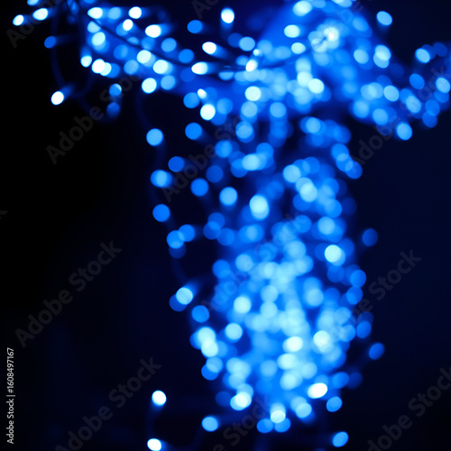 Stunning display of blue christmas lights twinkling against a dark background creating a magical holiday atmosphere full of charm.