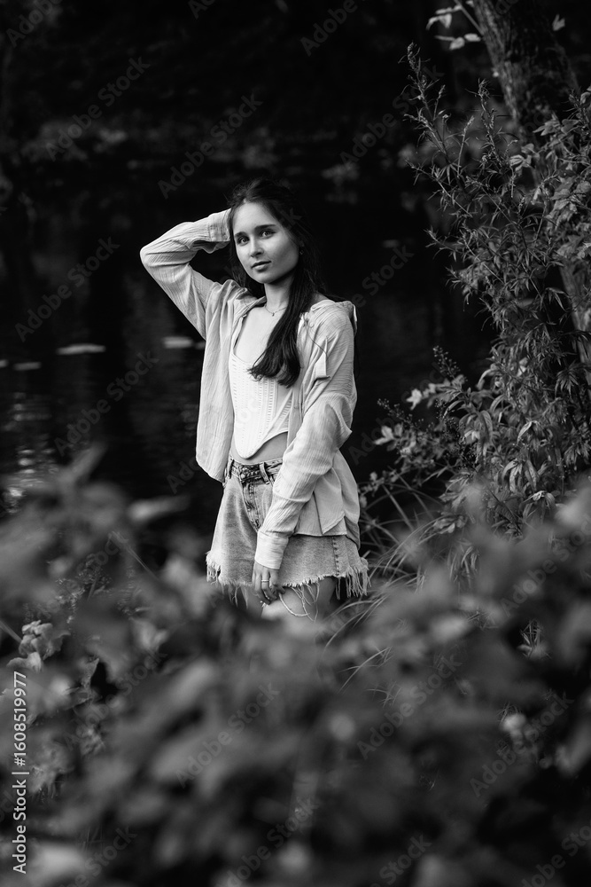 Portrait of a young beautiful dark-haired girl in the forest. Vintage black and white photo. Portrait of a young beautiful dark-haired girl in the forest. Vintage black and white photo.