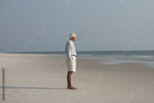 elderly man stands in despair against clean ultrabright background embodying moment of vulnerability