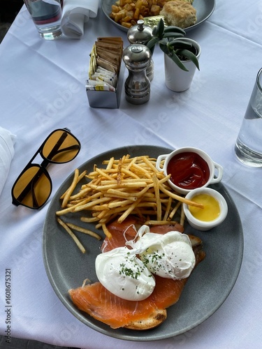 brunch table setting at restaurant, eggs and salmon
