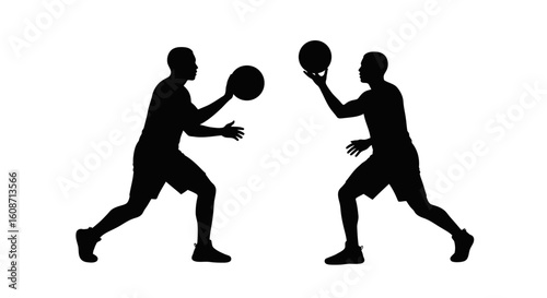 Two basketball players passing the ball to each other silhouette