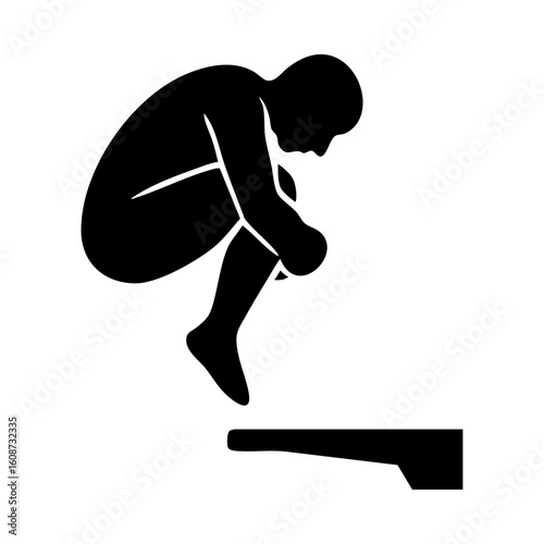 Silhouette of diver in tuck position above diving board
