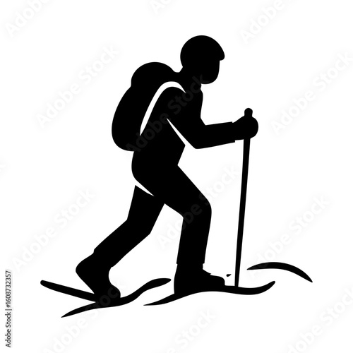 Silhouette of person snowshoeing through snowy terrain