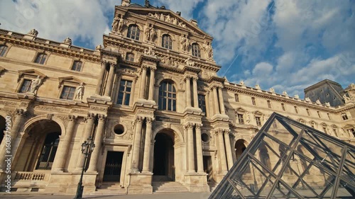 Famous Louvre Museum in Paris city center with tourists exploring cultural landmarks and beautiful European architecture in the historical district of France
