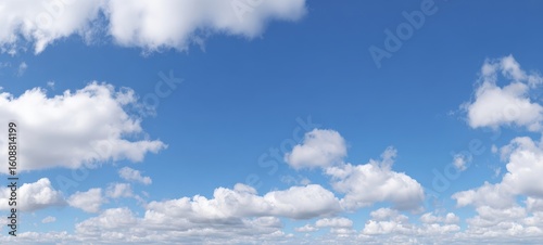 Fototapeta Naklejka Na Ścianę i Meble -  The bright blue sky filled with soft, fluffy clouds on a sunny day.