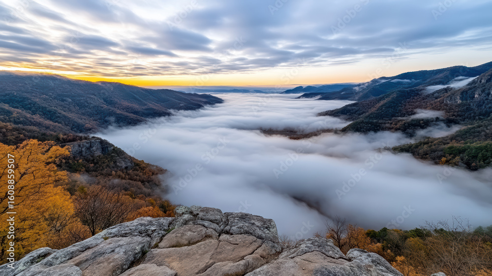 Fototapeta premium Majestic valley shrouded in cloud inversion, showcasing autumn foliage and serene landscape