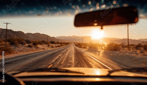 Driving along a sun-drenched desert highway at sunset evokes a sense of freedom and adventure with the open road stretching into the distance.