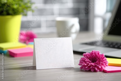 Blank card on a desk with flowers and colorful sticky notes