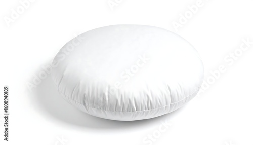 A plump, round white pillow sits on a white background, casting a subtle shadow