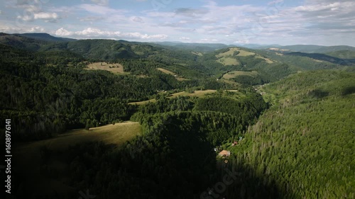 Beautiful summer Slovak nature. Large hills covered with forests and meadows. Drone video.