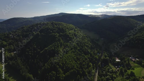 Beautiful summer Slovak nature. Large hills covered with forests and meadows. Drone video.