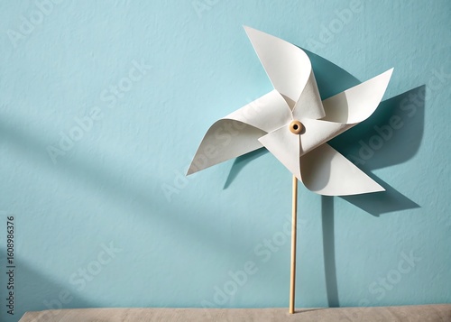 Paper Windmill Spinning from Pin on Wall